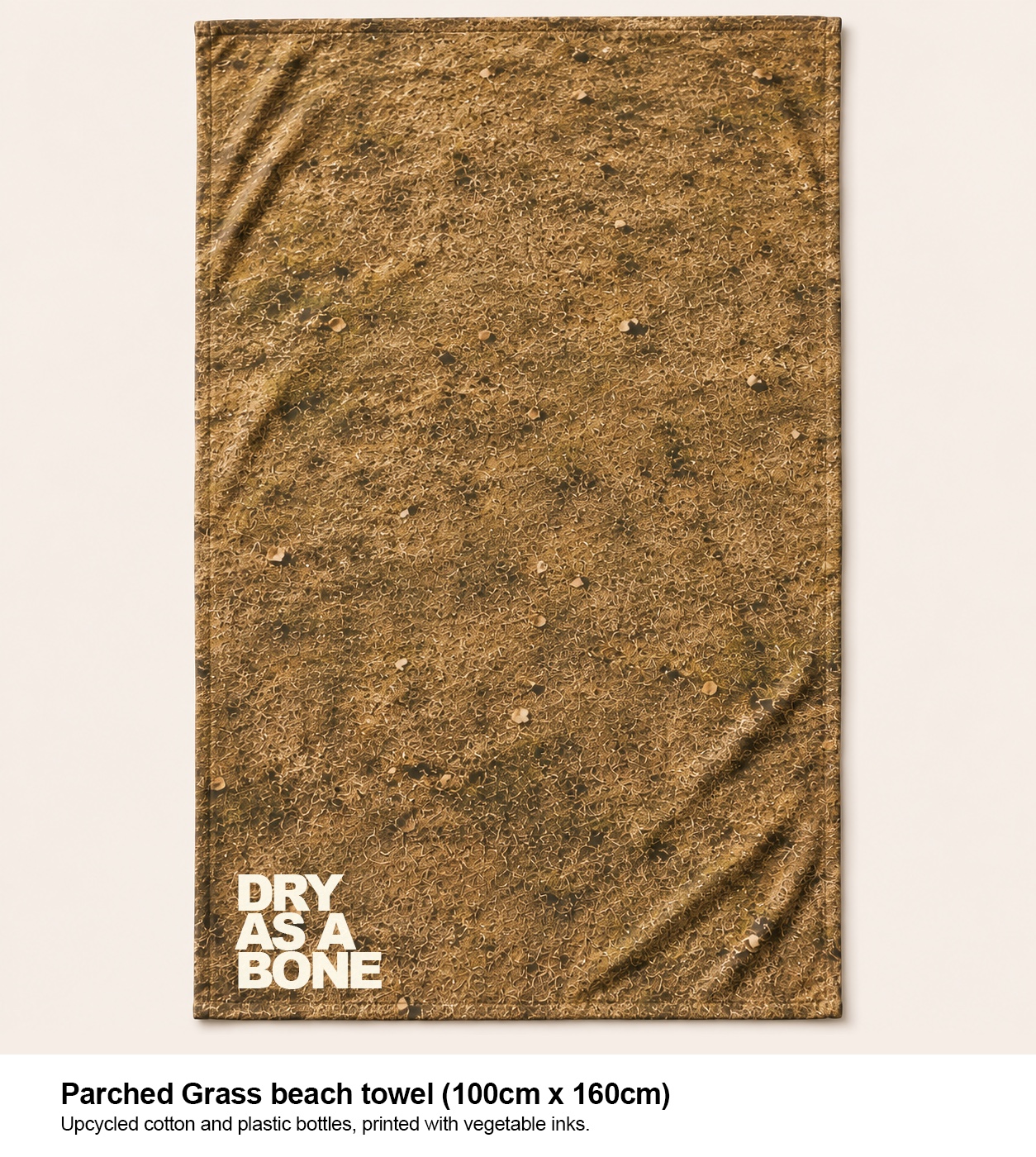 Parched Grass beach towel with DRY AS A BONE branding